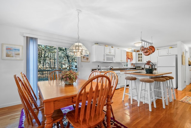 dining room featuring a notable chandelier and light hardwood / wood-style flooring