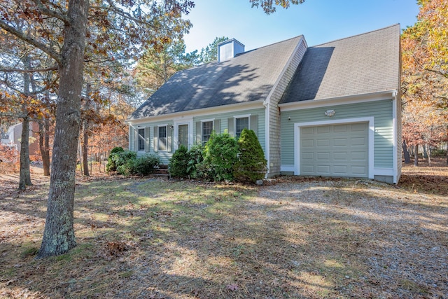 cape cod home featuring a garage