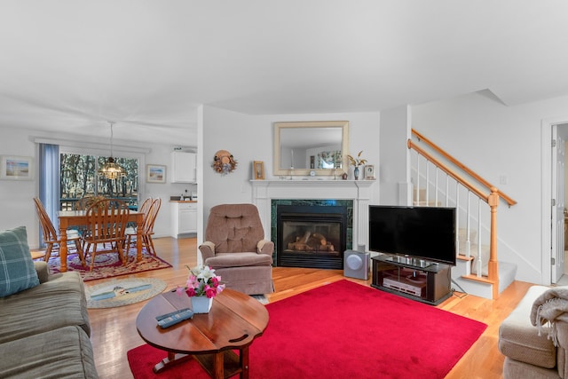 living room featuring hardwood / wood-style flooring and a high end fireplace