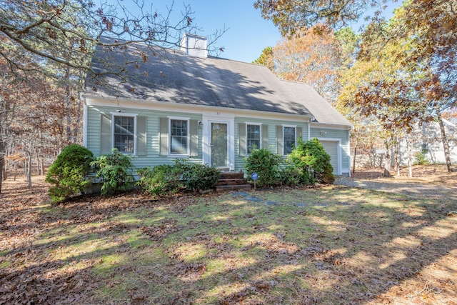 cape cod-style house featuring a garage