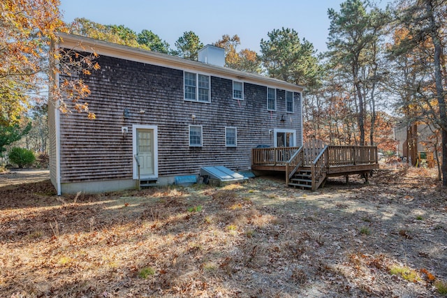 rear view of property featuring a deck