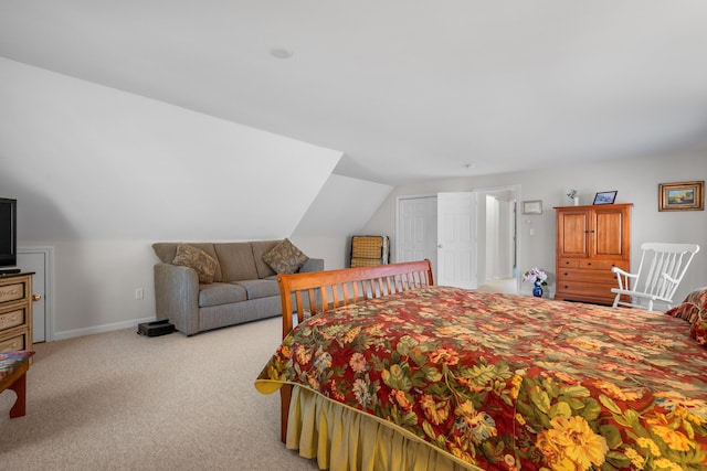 bedroom with light carpet and vaulted ceiling