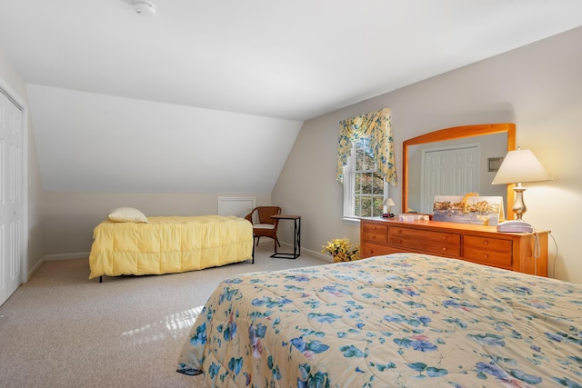 bedroom featuring light carpet, a closet, and lofted ceiling