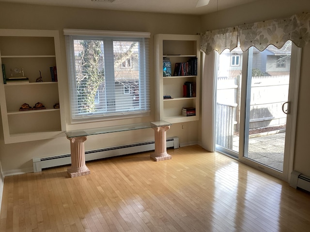 interior space featuring light hardwood / wood-style floors and baseboard heating