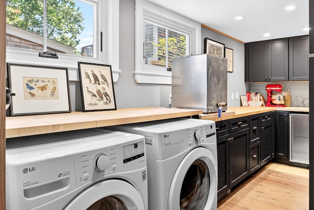 7 Anthony St, Provincetown, MA 02657 - washroom featuring cabinet space, washing machine and clothes dryer, recessed lighting, and light wood-type flooring