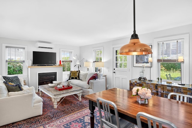 7 Anthony St, Provincetown, MA 02657 - dining area featuring a wall mounted air conditioner and a glass covered fireplace