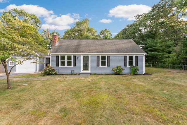 view of front of property featuring a garage and a front lawn