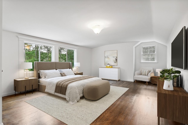 bedroom featuring dark hardwood / wood-style floors and lofted ceiling