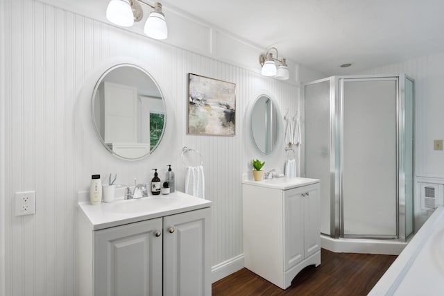 bathroom with a shower with door, wood-type flooring, and vanity