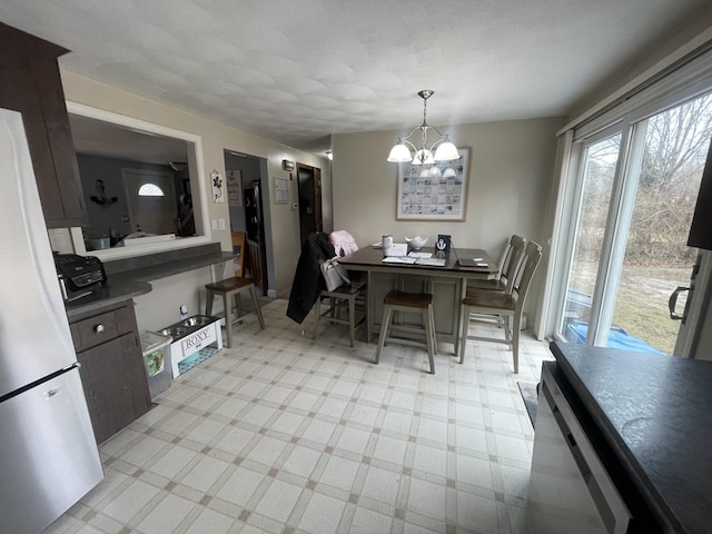 dining area featuring a notable chandelier