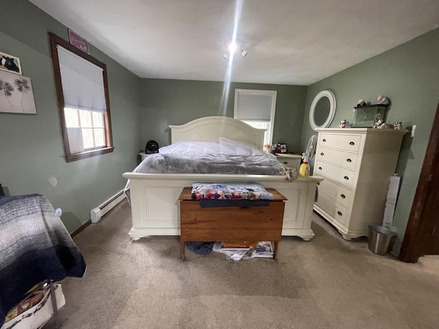 bedroom featuring a baseboard heating unit and carpet floors