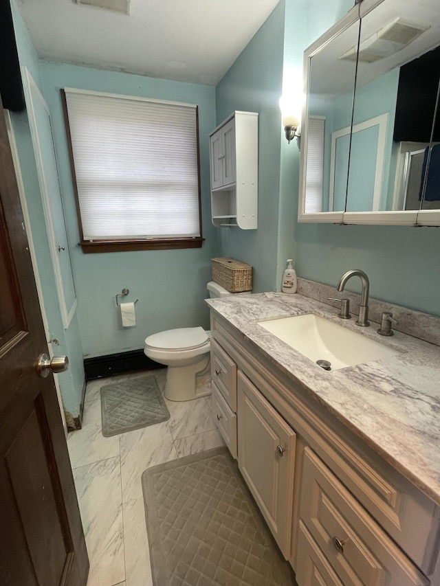 bathroom featuring toilet and vanity