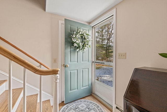 entryway featuring a baseboard heating unit and light wood-type flooring