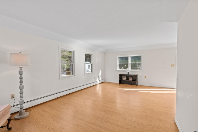 unfurnished living room with a baseboard radiator and light hardwood / wood-style flooring