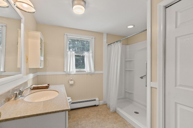 bathroom with baseboard heating, vanity, and a shower with curtain