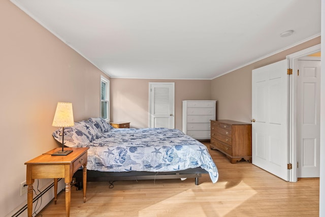 bedroom with crown molding, a baseboard radiator, and light wood-type flooring