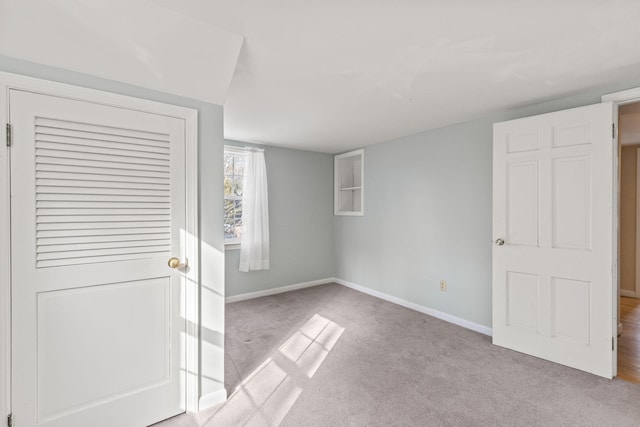 unfurnished bedroom featuring light carpet