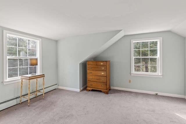 bonus room with light colored carpet, lofted ceiling, and a baseboard heating unit