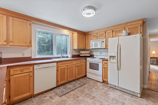 kitchen featuring sink and white appliances