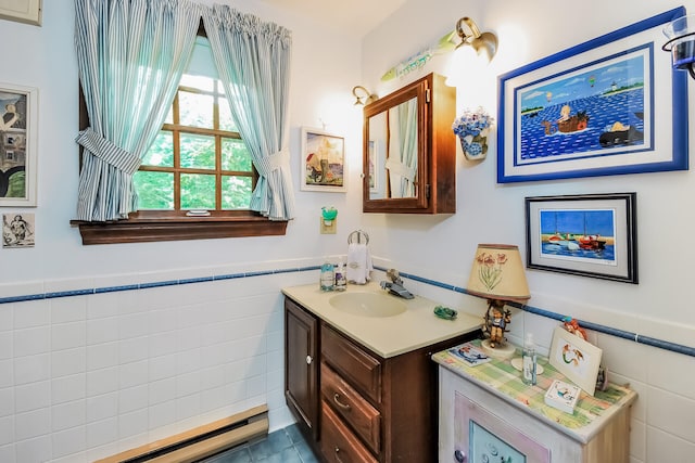 83 Colonial Way W, Falmouth, MA 02540 - bathroom featuring tile walls, a baseboard heating unit, a wainscoted wall, vanity, and tile patterned flooring