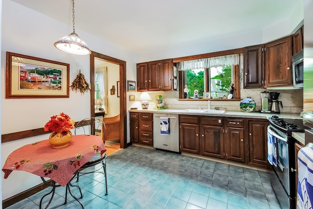 83 Colonial Way W, Falmouth, MA 02540 - kitchen featuring appliances with stainless steel finishes, a sink, light countertops, and decorative backsplash