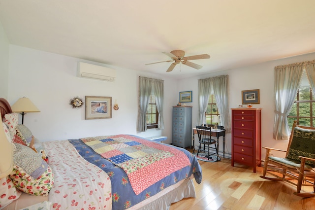 83 Colonial Way W, Falmouth, MA 02540 - bedroom featuring a wall unit AC, wood finished floors, and a ceiling fan