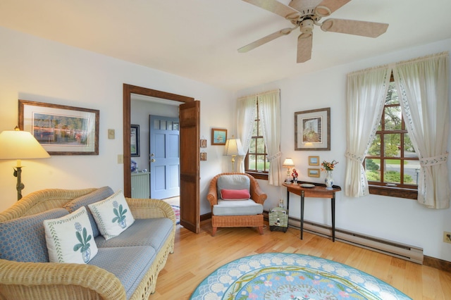 83 Colonial Way W, Falmouth, MA 02540 - living area with a baseboard radiator, wood finished floors, and ceiling fan