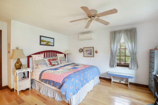 83 Colonial Way W, Falmouth, MA 02540 - bedroom featuring a wall mounted air conditioner, wood finished floors, a ceiling fan, and baseboards
