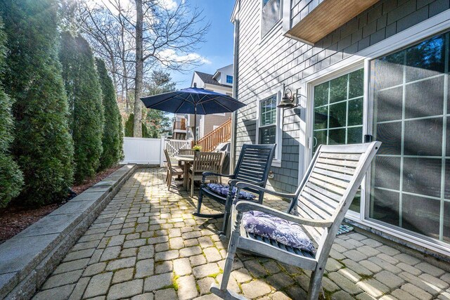 view of patio with outdoor dining area and fence