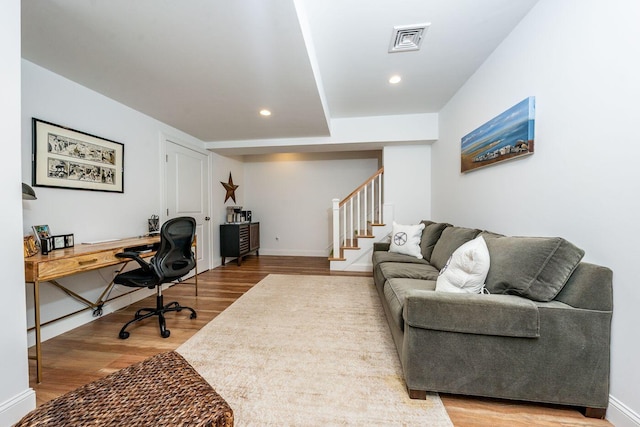 office space featuring baseboards, visible vents, wood finished floors, and recessed lighting