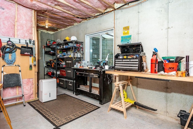 unfinished basement featuring a workshop area