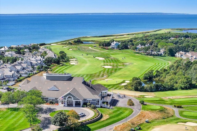 birds eye view of property featuring view of golf course and a water view