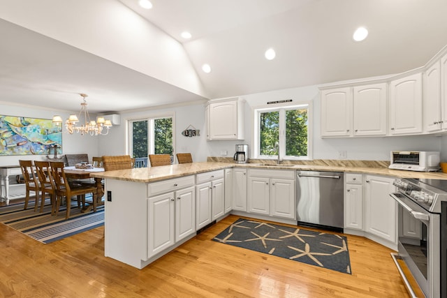 74 Deering Dr, Chatham, MA 02633 - kitchen featuring appliances with stainless steel finishes, a peninsula, healthy amount of natural light, light wood-style flooring, and recessed lighting