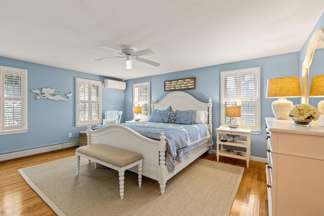 74 Deering Dr, Chatham, MA 02633 - bedroom with an AC wall unit, a baseboard radiator, multiple windows, and light wood finished floors