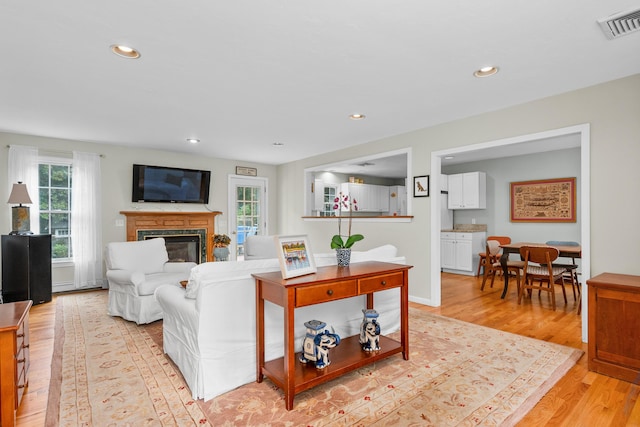2 Julie Ln, Cotuit, MA 02635 - living area featuring plenty of natural light, a glass covered fireplace, light wood finished floors, and recessed lighting