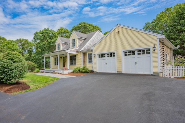 2 Julie Ln, Cotuit, MA 02635 - cape cod-style house with a porch, asphalt driveway, and a garage