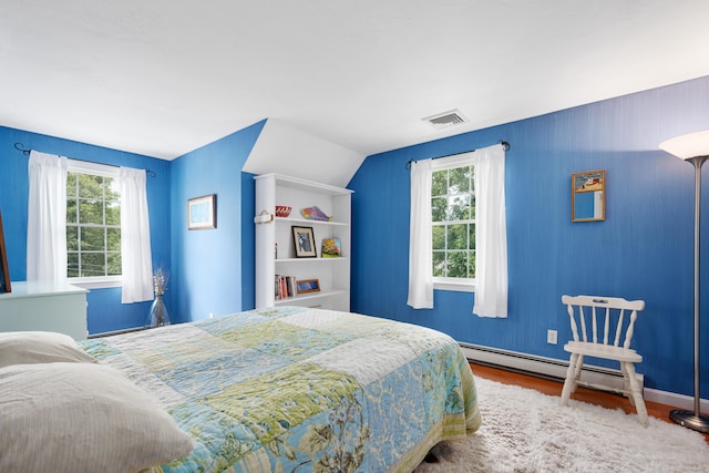 2 Julie Ln, Cotuit, MA 02635 - bedroom featuring wood finished floors, multiple windows, and a baseboard heating unit