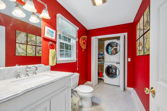 2 Julie Ln, Cotuit, MA 02635 - laundry area with estacked washer and dryer and light tile patterned floors