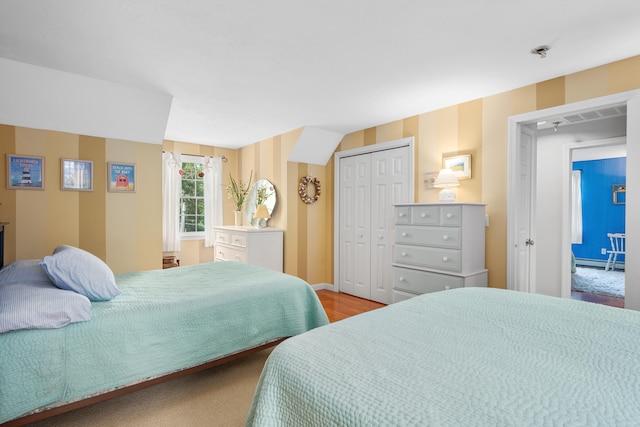 2 Julie Ln, Cotuit, MA 02635 - bedroom featuring a closet, wood finished floors, and a baseboard radiator