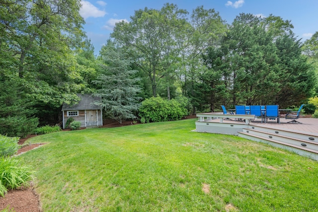 2 Julie Ln, Cotuit, MA 02635 - view of green lawn with a shed, a wooden deck, and outdoor dining area