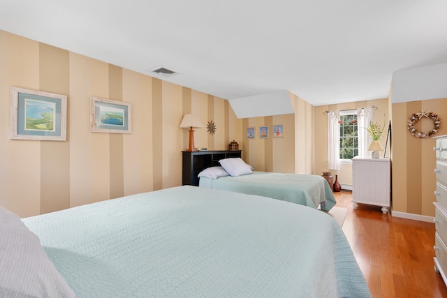 2 Julie Ln, Cotuit, MA 02635 - bedroom featuring wallpapered walls, wood finished floors, and baseboard heating