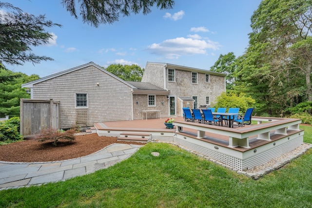 2 Julie Ln, Cotuit, MA 02635 - rear view of house with a deck, outdoor dining area, and a lawn