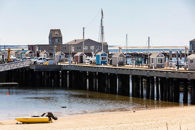 view of dock featuring a water view and a view of the beach