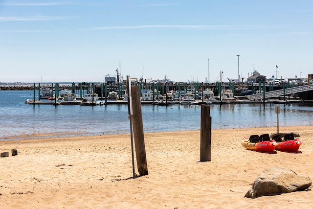 exterior space featuring a view of the beach and a boat dock