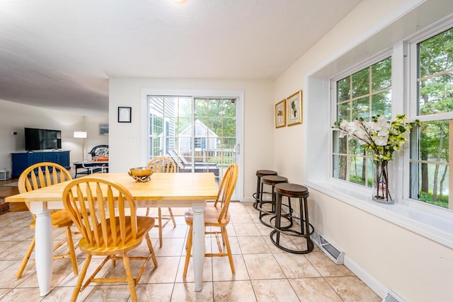 dining space featuring light tile patterned floors