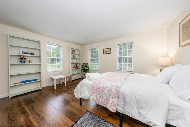 bedroom with dark hardwood / wood-style floors