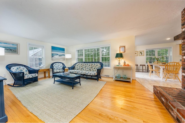 living room with a healthy amount of sunlight and hardwood / wood-style floors