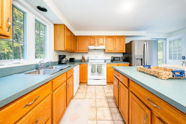 kitchen featuring sink, appliances with stainless steel finishes, and light tile patterned floors