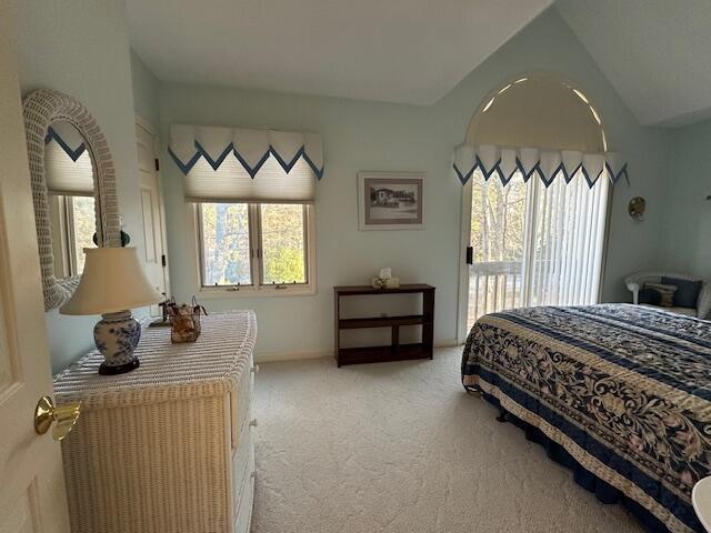 bedroom featuring light carpet, access to exterior, baseboards, and lofted ceiling