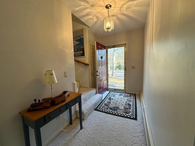 doorway to outside with carpet floors, stairway, and baseboards